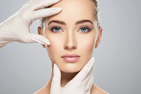Face skin check before plastic surgery. Beautician touching woman face.